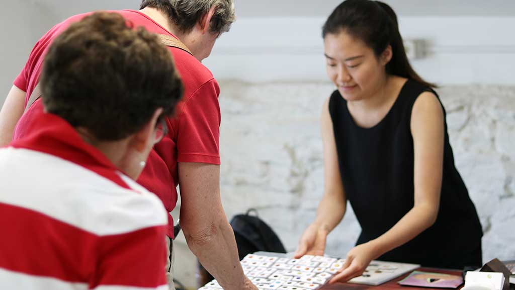 Adults in class looking at glaze color options