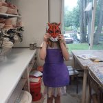 A girl wearing the tiger mask she made