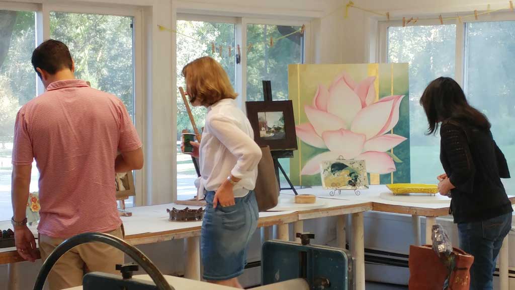 Three visitors enjoying the art at a students & teachers art expo